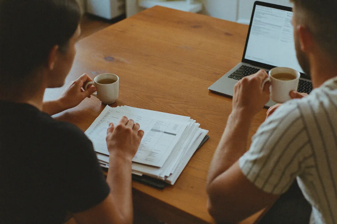 A first-home-buyer couple reviewing their contract and Form 1 vendor statement at home during South Australia's two-day cooling-off period.
