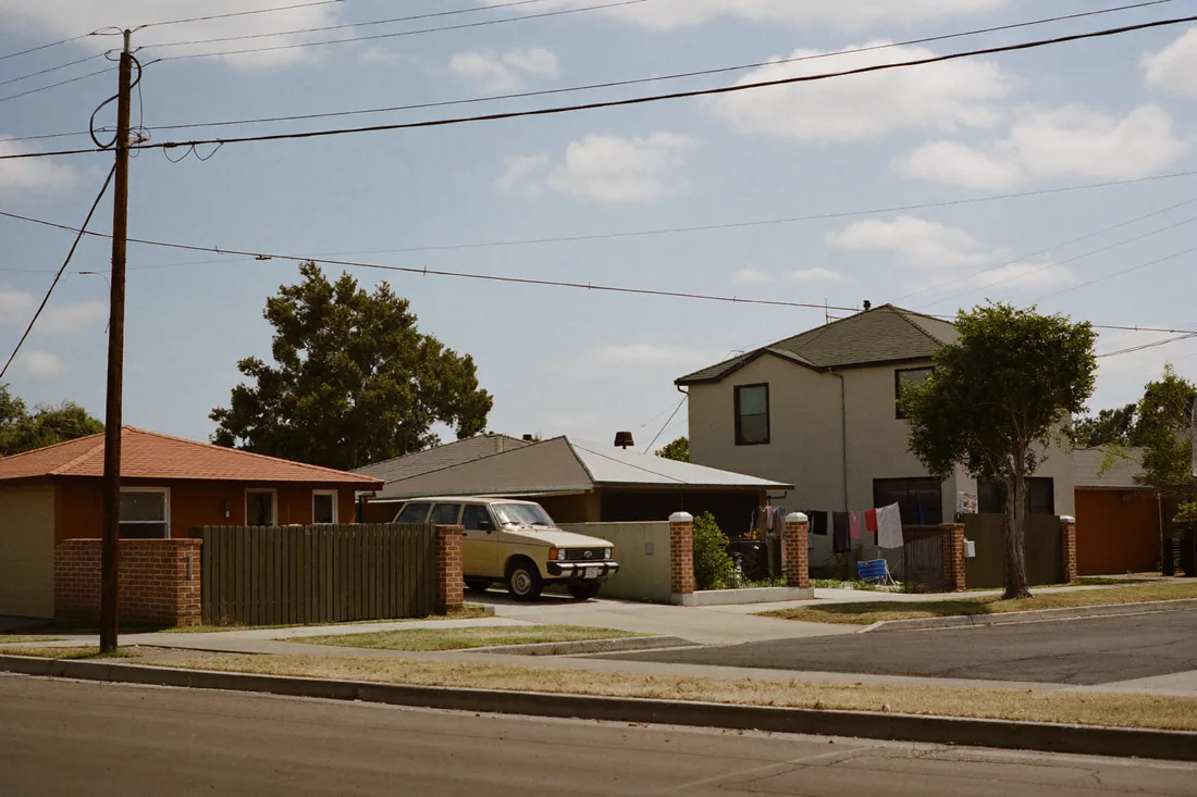 Quiet residential street of brick-and-tile houses in a Western Sydney first-home-buyer suburb.