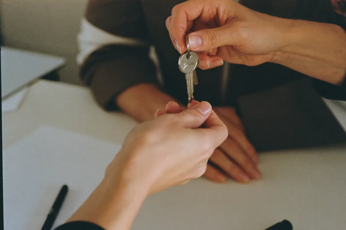 House keys being handed over to a first home buyer at settlement in Australia.