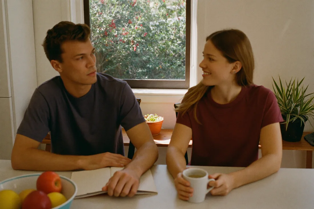 First home buyers talking through their home insurance options at the kitchen table before settlement.