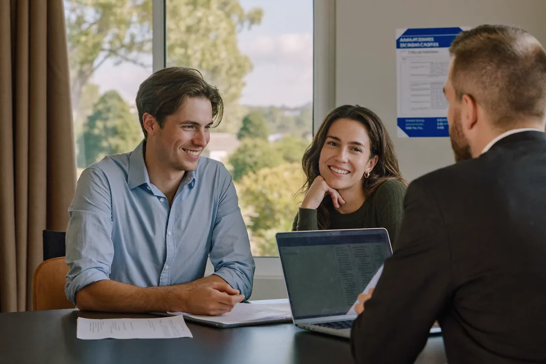 A first-home-buyer couple meeting a mortgage broker to discuss home loan pre-approval.