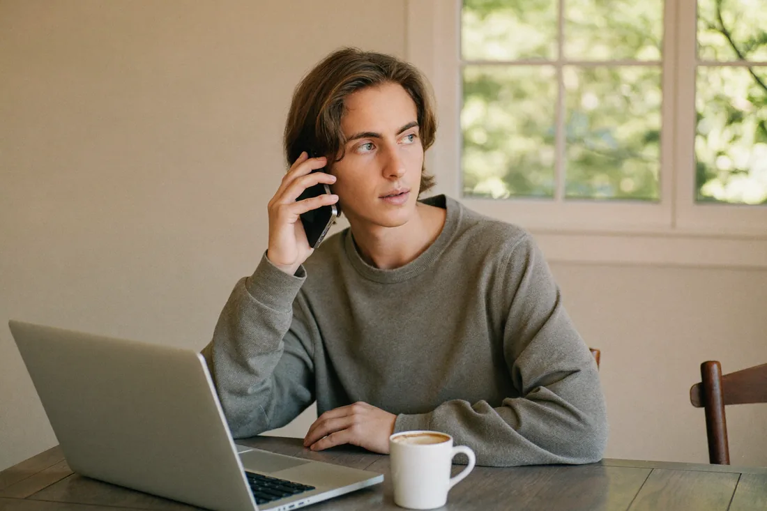 A first home buyer reviewing a broker's loan recommendation and paperwork at home before signing.