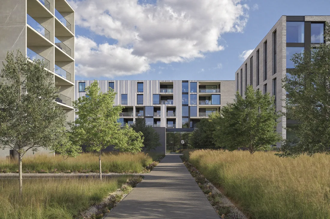 A modern Australian apartment building with shared gardens, lift access and common areas — the kind of common property that strata fees pay to maintain.