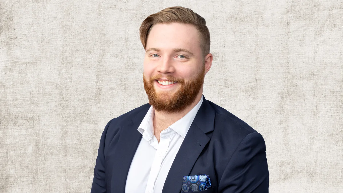 Alex Henwood, finance broker at Home Loan Solutions, in a navy blazer and white shirt